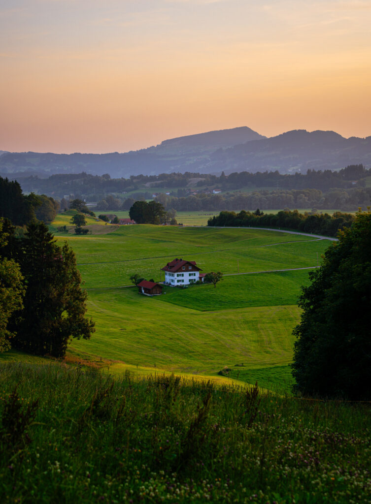 Traditional Allgäu farmhouse at sunset