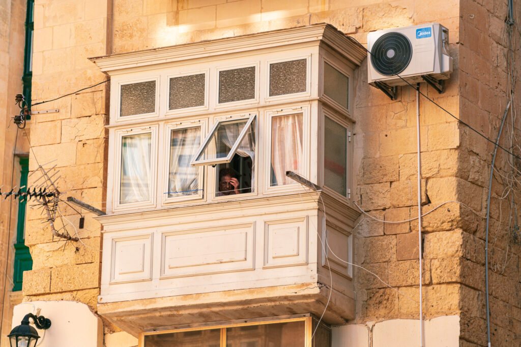 Old lady at the bay window